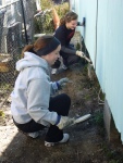 Jessica and Hilary working on the side of house